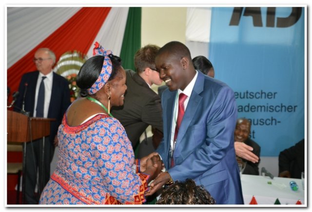 h.e. governor congragulating project leader from tanzania